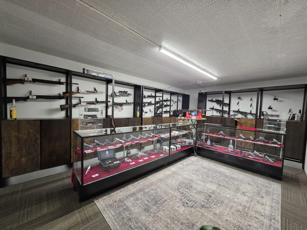 Firearms displayed on wall racks and in glass cases