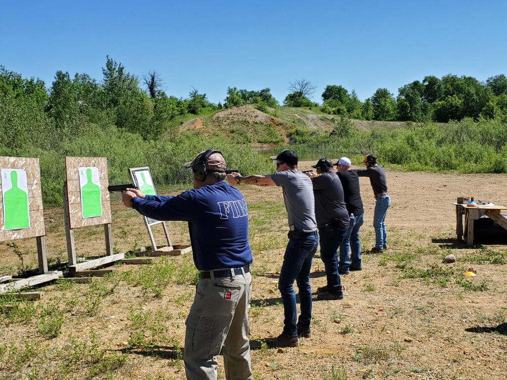 Participants practicing at an outdoor shooting range