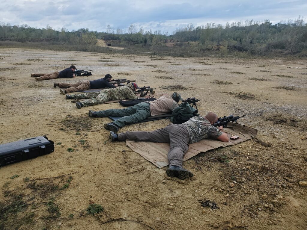 Participants lying on shooting mats at an outdoor range