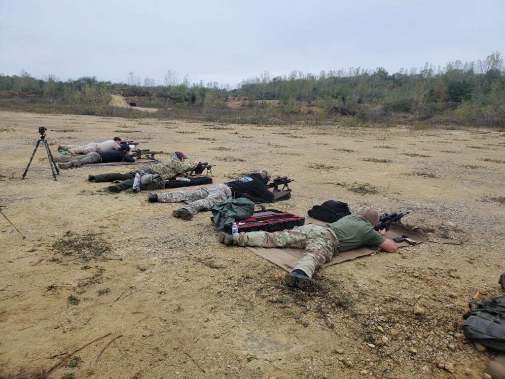 Participants lying on shooting mats at an outdoor range