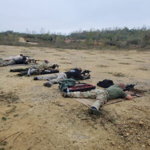 Participants lying on shooting mats at an outdoor range