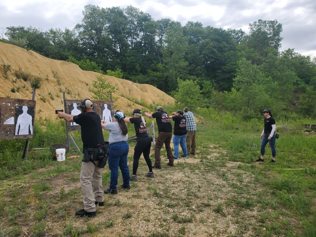 Participants practicing at an outdoor shooting range