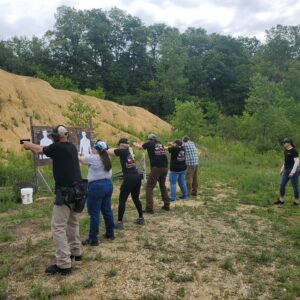 Participants practicing at an outdoor shooting range