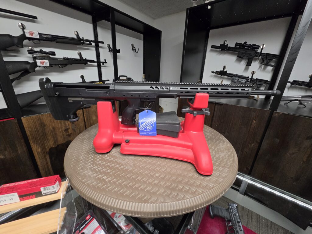 Firearm secured in a bench vise inside the shop