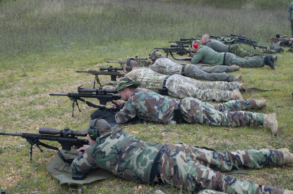Participants lying on shooting mats at an outdoor range