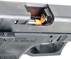 Close-up of a cartridge in a handgun ejection port